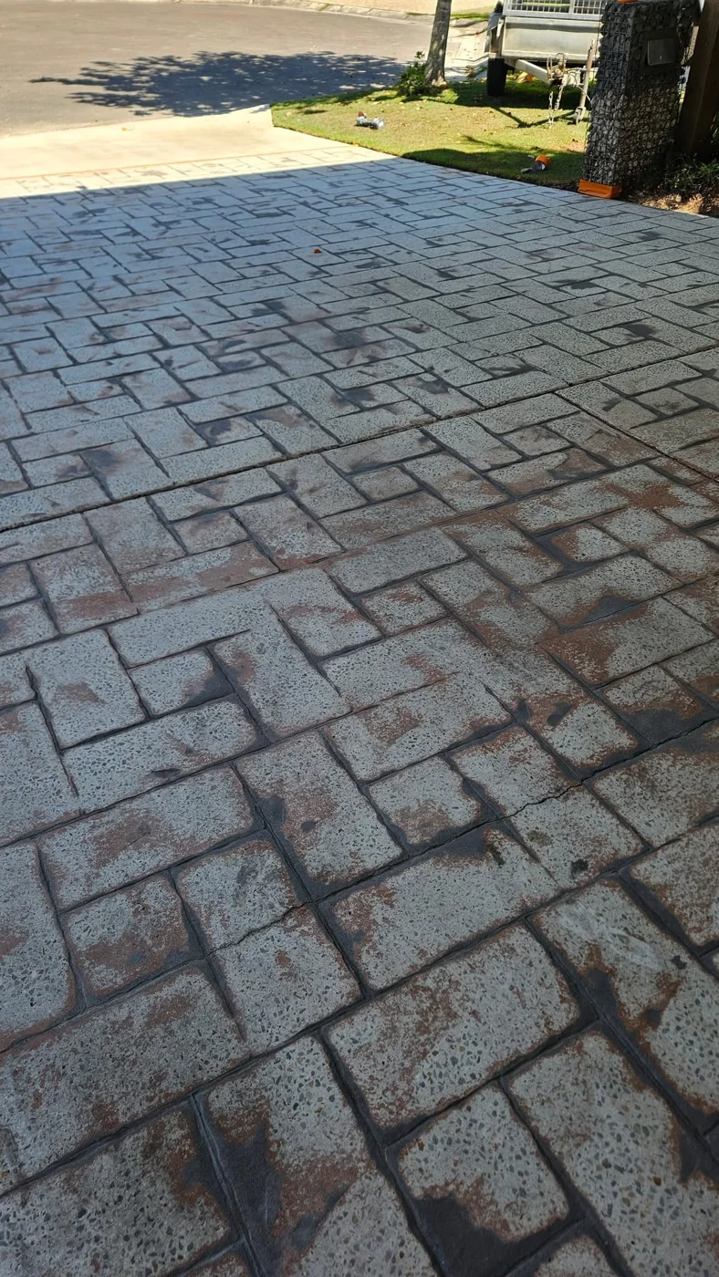 Before: older stamped driveway showing worn colour and cracking